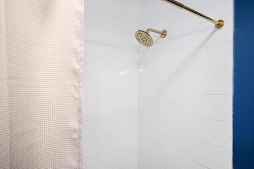 a shower with a shower curtain in a bathroom at Luxurious Extended Stay Dream~3 Kings~Desks~TV's in Snellville