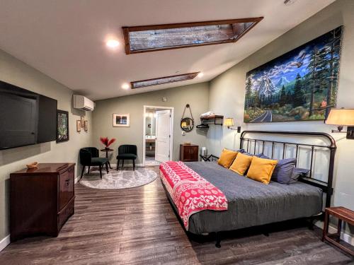 a bedroom with a bed and a flat screen tv at Sea Glass Inn in Seaside