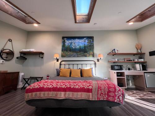 a bedroom with a bed and a painting on the wall at Sea Glass Inn in Seaside
