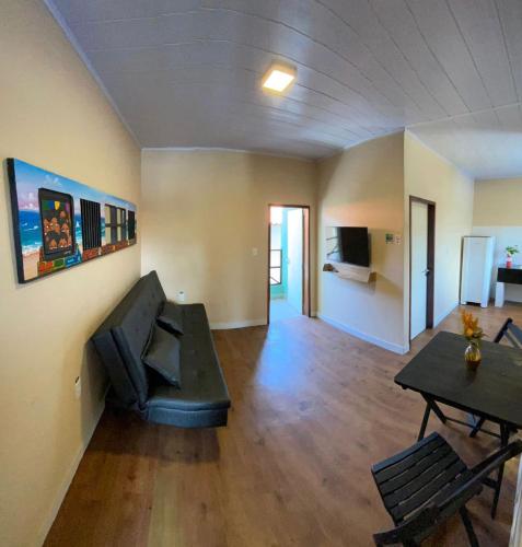 a living room with a couch and a table at Tamandaré Praia Hotel in Tamandaré