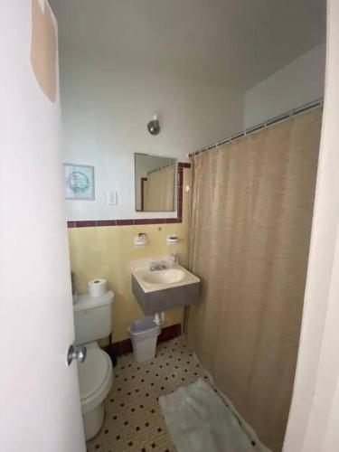 a bathroom with a toilet and a sink at Private Studio 15 -Directly Across from Beach in St Pete Beach