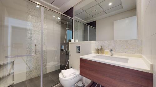 a bathroom with a toilet and a sink and a shower at Primestay - Prime Views 1BR, Meydan in Dubai