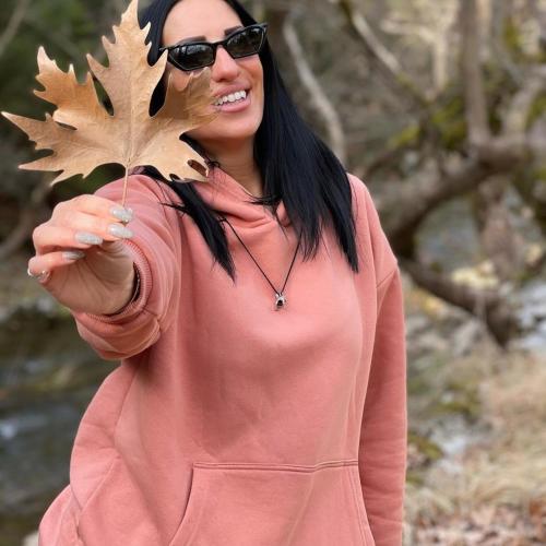 a woman wearing sunglasses holding a maple leaf at Archontiko Nikolopoulou in Vytina