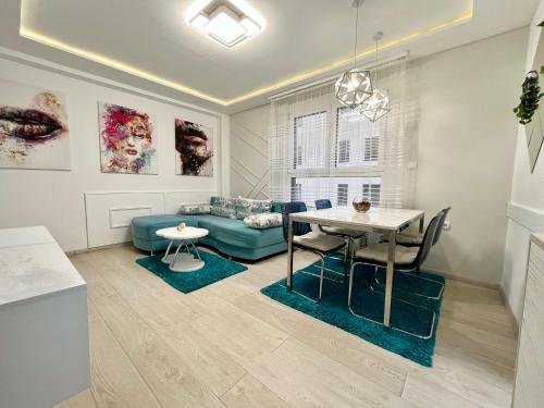 a living room with a table and a couch at Apartmani SLEEP&JOY in Zlatibor