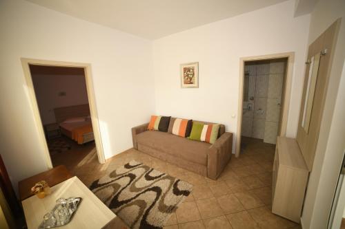 a living room with a couch and a table at Pensiunea Zbor in Cluj-Napoca