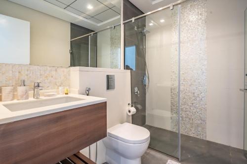 a bathroom with a sink and a toilet and a shower at Al Meydan - Prime Views 1BR in Al Meydan in Dubai