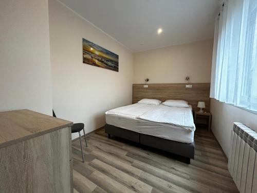 a bedroom with a bed and a desk in a room at SIEDEM WYDM in Rowy