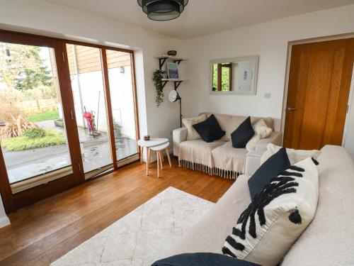 a living room with a couch and a table at Little Rondeval in Totnes