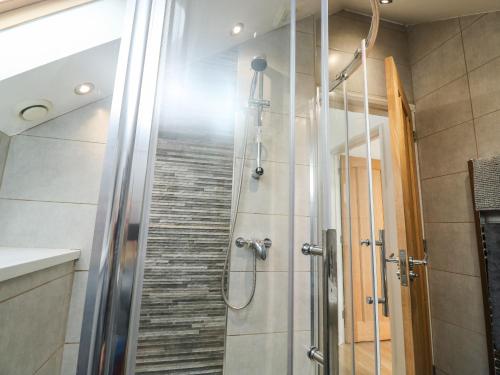 a shower with a glass door in a bathroom at Little Rondeval in Totnes