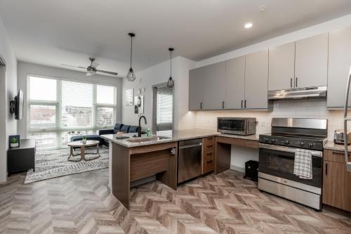 a kitchen with white cabinets and a counter top at Yugo Guest Suites in Urbana