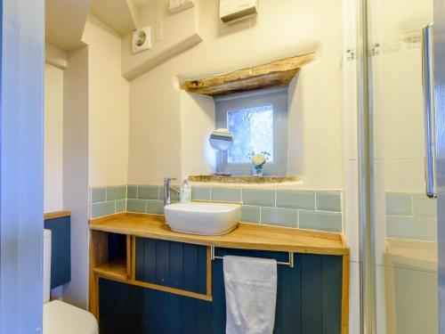 a bathroom with a sink and a shower at 2 Bed in Crickhowell 42920 in Llangattock