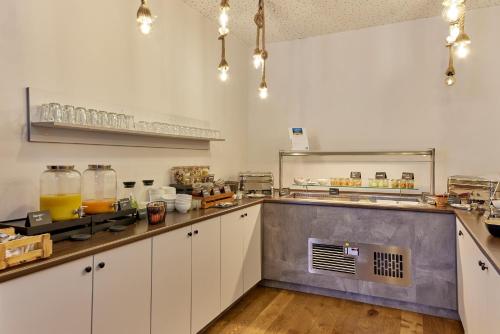 a large kitchen with white cabinets and a counter top at Moselhotel Römischer Kaiser in Bernkastel-Kues