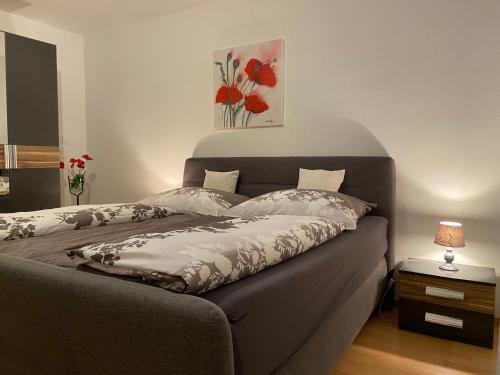 a bedroom with a bed with red flowers on it at Ferienwohnung Familie Meinschad in Rietz