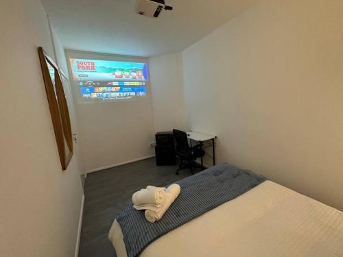 a hotel room with a bed and a television at Small cozy private bedroom zone1 in London