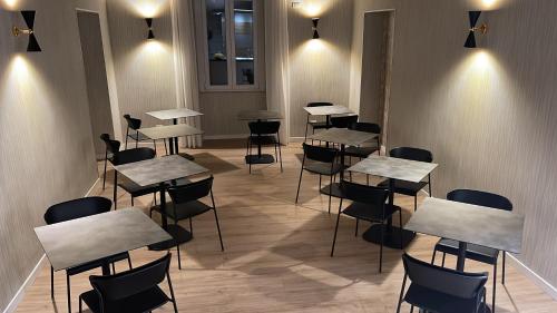 a row of tables and chairs in a room with lights at ROME'S GLORIA HOTEL in Rome