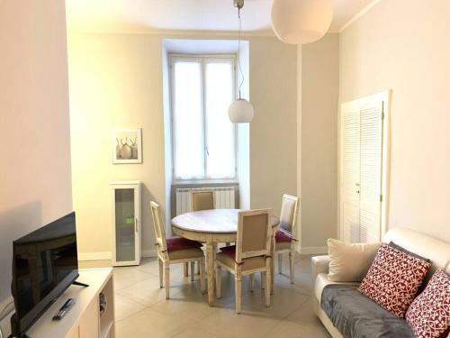a living room with a table and a couch at "le Volte" Appartamento nel cuore di Foligno in Foligno