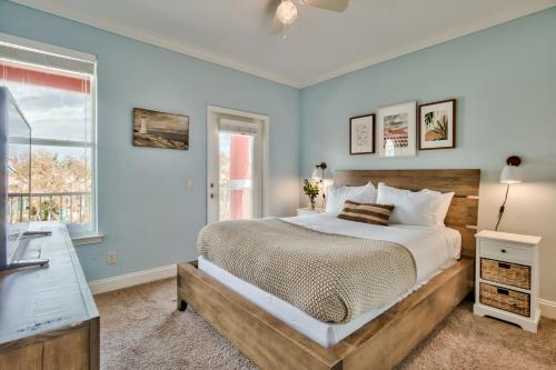 a bedroom with a large bed and a window at Coral By AvantStay Gorgeous Three Story Home w Two Balconies in Destin