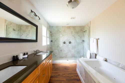a bathroom with a large tub and a sink at West Ridge by AvantStay A Place Of Comfort Perfect Sunsets by the Pool ❤ in Scottsdale