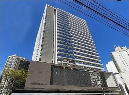 a tall building with many windows in a city at hihome - Independência 915 in Juiz de Fora