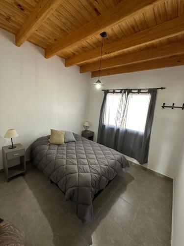 a bedroom with a bed and a large window at Increíble departamento a estrenar en Mendoza in Godoy Cruz