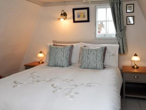 a bedroom with a white bed with two lamps at 2 Bed in Brede 46895 in Brede