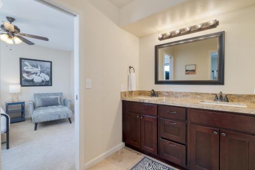 a bathroom with two sinks and a mirror at Sonoran Sunshine by AvantStay Pool Putting Green BBQ Ping Pong Pool Table Entertainers Wonderland in Scottsdale