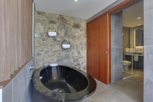 a bathroom with a large black tub in a room at Hotel Porto Sol Beach in Florianópolis