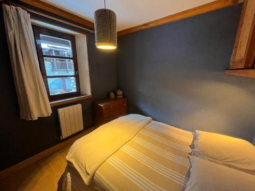 um quarto com uma cama e uma janela em Adorable 30m2 Coeur de Val 1 chambre 2 lits em Val dʼIsère