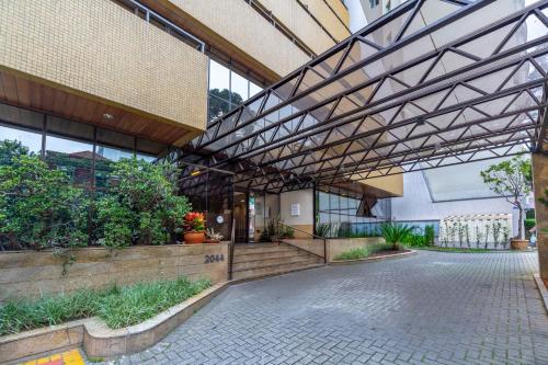 a large building with a metal roof and a walkway at Mercure Curitiba Golden in Curitiba