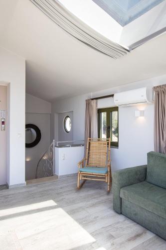 a living room with a couch and a chair at Aléa Villa Plakias in Plakias