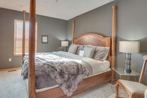 1 dormitorio con 1 cama con marco de madera en Akron Home with Deck Walk to Towpath Trail!, en Akron