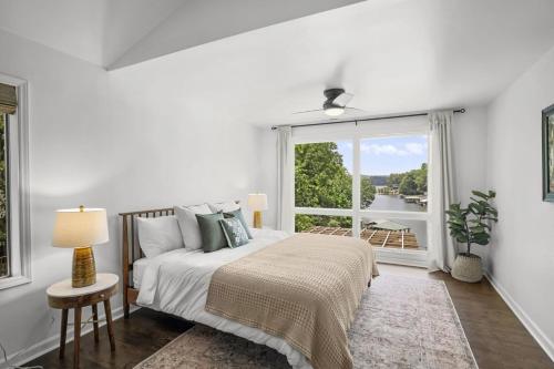 Habitación blanca con cama y ventana en Hummingbird Home by AvantStay Boat House Dock, en Statesville