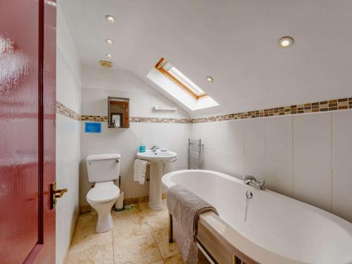a bathroom with a tub and a toilet and a sink at 2 bed in Appleby 87537 in Long Marton