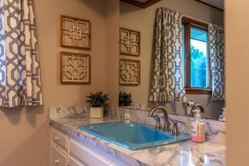 a bathroom with a sink and a window at Dogwood Retreat with big pool! in Warsaw