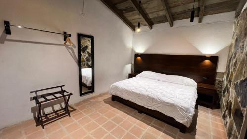 a bedroom with a large bed in a room at La Peña Hotel Boutique & SPA in Cuetzalán del Progreso