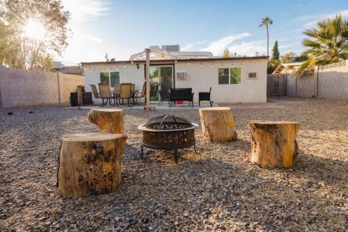 a backyard with three logs and a fire pit at Sunny Guest Suite with large backyard - Pets Welcome in Phoenix