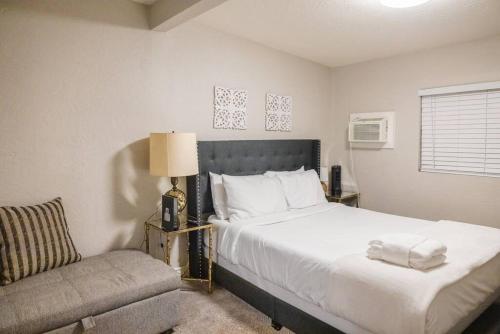 a bedroom with a large bed and a chair at Sunny Guest Suite with large backyard - Pets Welcome in Phoenix