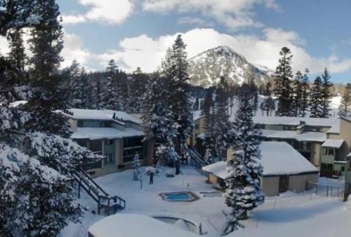 a ski lodge with snow covered trees and buildings at St Anton Condos #77 condo in Mammoth Lakes