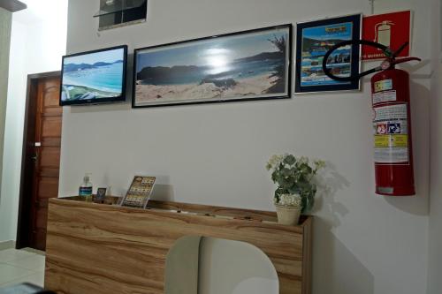 a room with a fire hydrant and pictures on the wall at CANTO DA ARVORE 1 in Arraial do Cabo