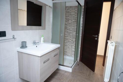 a bathroom with a white sink and a shower at B&B Vista Mare "Terrazzo" in Palmi