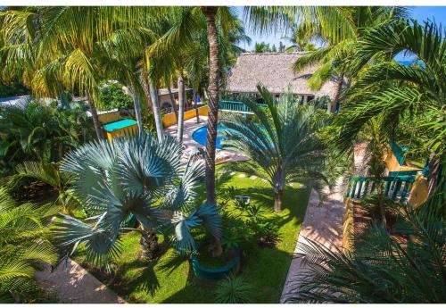 an aerial view of a resort with palm trees and a swimming pool at Bungalows Oasis in Puerto Escondido
