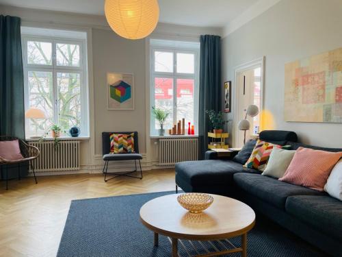 a living room with a couch and a table at Cool and light 2 room apartment in SoFo in Stockholm