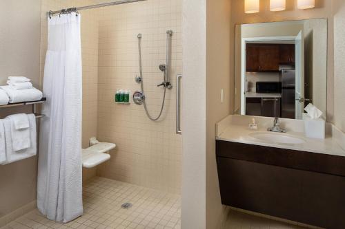 a bathroom with a shower and a sink and a toilet at TownePlace by Marriott Suites Clarksville in Clarksville