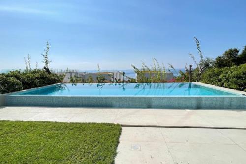 a swimming pool in the middle of a yard at Amchit Bay Beach Residences 2BR w Private Pool in Jbeil