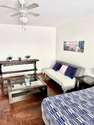 a living room with two beds and a couch at Lima Mini Aparts Monterrico - Cerca Embajada EEUU in Lima