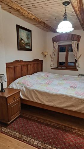 a bedroom with a large bed and a window at GAJRAJ in Wünschelburg