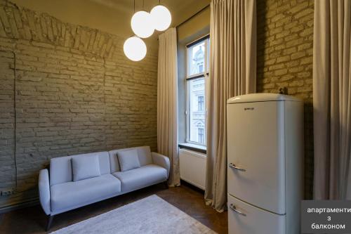 a living room with a couch and a window at Apart hotel на Франка in Chernivtsi