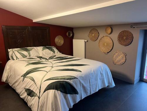 - une chambre avec un lit et quelques assiettes murales dans l'établissement Chez Montgaud, à Verdun-sur-Meuse