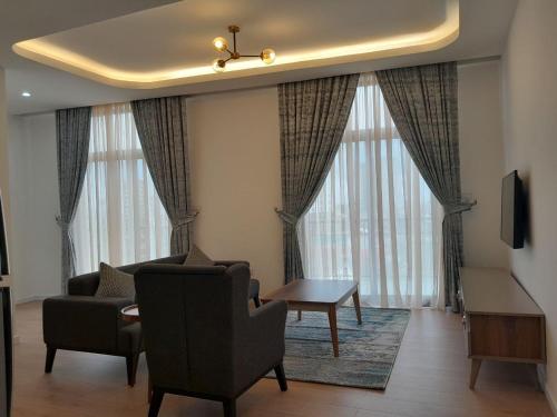 a living room with a couch and a chair at Zemilo Hotel Apartment in Addis Ababa