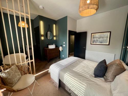 a bedroom with a bed and a chair in it at Lancaster Place 20 in Carnforth